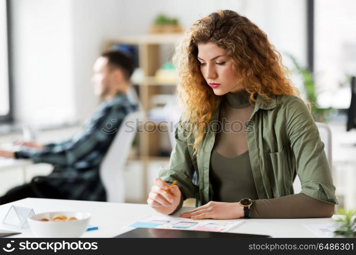 business, technology and people concept - creative woman or developer working on user interface design at office. creative woman working on user interface at office. creative woman working on user interface at office