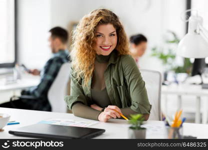 business, technology and people concept - creative woman or developer working on user interface design at office. creative woman working on user interface at office. creative woman working on user interface at office