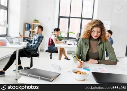 business, technology and people concept - creative woman or developer working on user interface design at office. creative woman working on user interface at office