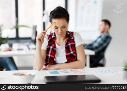 business, technology and people concept - creative woman or developer working on user interface design at office. creative woman working on user interface at office