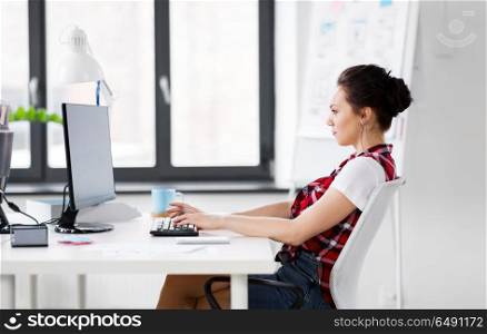 business, technology and people concept - creative woman with computer working at office. creative woman with computer working at office. creative woman with computer working at office