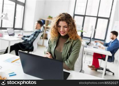 business, technology and people concept - creative woman with laptop computer working at office. creative woman with laptop working at office. creative woman with laptop working at office