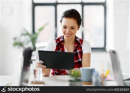 business, technology and people concept - creative woman with tablet pc computer working at office. creative woman with tablet pc working at office. creative woman with tablet pc working at office