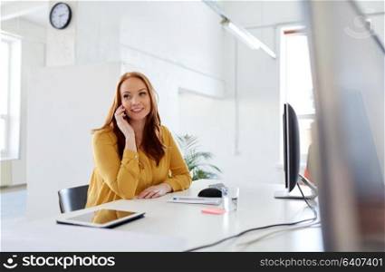 business, technology and people concept - happy businesswoman or creative worker calling on smartphone at office. businesswoman calling on smartphone at office