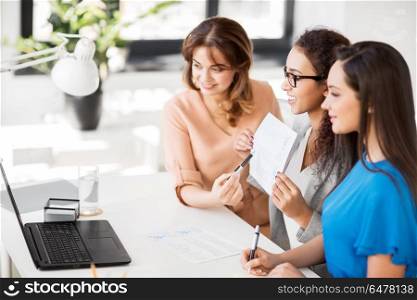 business, technology and people concept - happy smiling female teambusinesswomen with papers having video conference by laptop computer at office. businesswomen having video conference at office. businesswomen having video conference at office