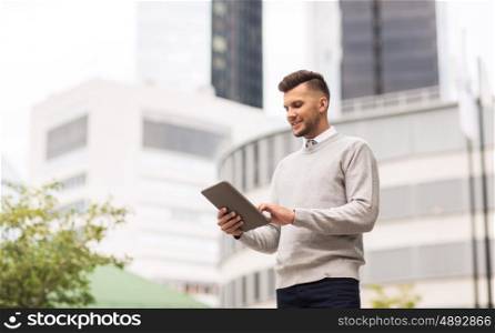 business, technology and people concept - happy smiling man with tablet pc computer in city