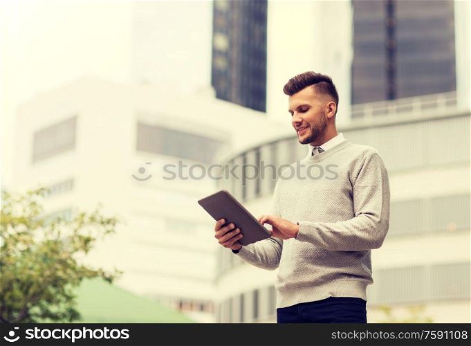 business, technology and people concept - happy smiling man with tablet pc computer in city. happy man with tablet pc computer in city