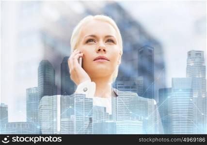 business, technology and people concept - serious businesswoman calling on smartphone over city and office buildings with charts background. serious businesswoman with smartphone in city