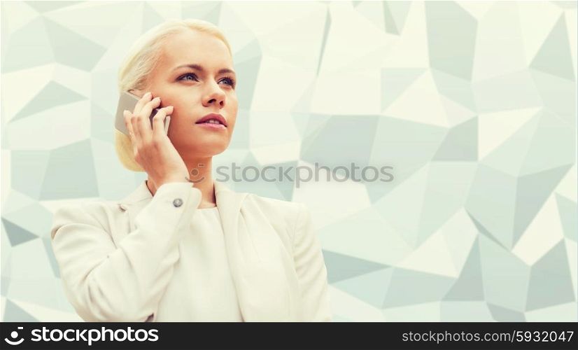business, technology and people concept - serious businesswoman with smartphone talking over gray graphic low poly background