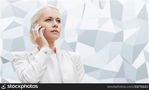 business, technology and people concept - serious businesswoman with smartphone talking over gray graphic low poly background