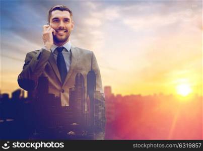 business, technology and people concept - smiling businessman with smartphone talking over city and sun light background and double exposure. smiling businessman with smartphone outdoors