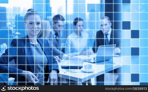business, technology and people concept - smiling businesswoman and team at office over blue squared grid background