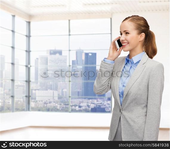 business, technology and people concept - smiling businesswoman calling on smartphone over office room or new apartment background