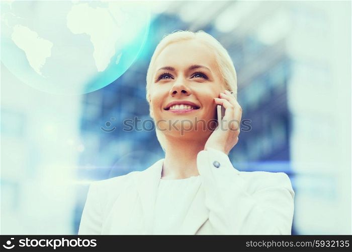 business, technology and people concept - smiling businesswoman with smartphone and globe hologram talking over office building