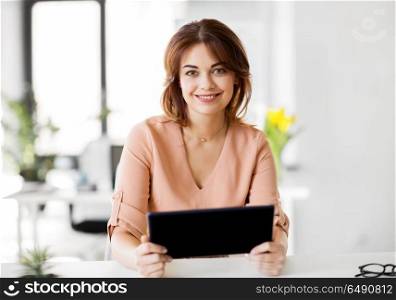 business, technology and people concept - smiling businesswoman with tablet pc computer working at office. businesswoman with tablet pc working at office. businesswoman with tablet pc working at office