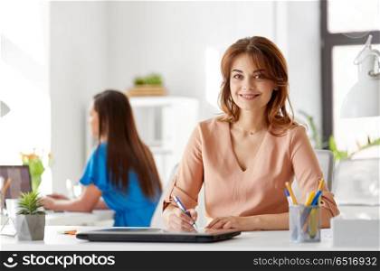 business, technology and people concept - smiling businesswoman working at office. smiling businesswoman working at office. smiling businesswoman working at office