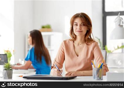 business, technology and people concept - smiling businesswoman working at office. smiling businesswoman working at office. smiling businesswoman working at office