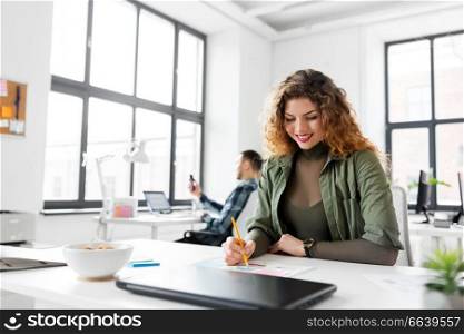 business, technology and people concept - smiling creative woman or developer working on user interface design at office. creative woman working on user interface at office
