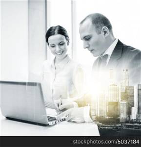 business, technology and people concept - smiling team with laptop computer working at office over city buildings and double exposure effect. business team with laptop working at office
