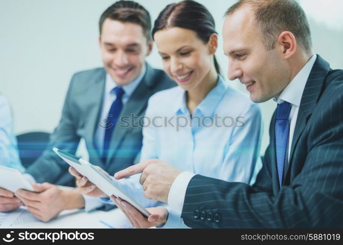 business, technology and teamwork concept - business team with tablet pc computer having discussion in office