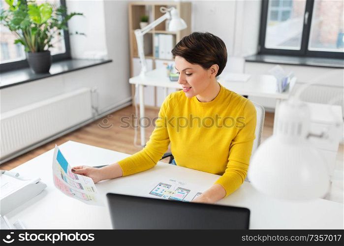 business, technology and ui design concept - happy creative woman with user interface templates working at office. creative woman working on user interface at office
