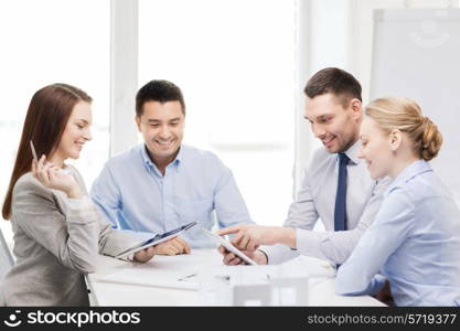 business, technology, architecture and office concept - happy team of architects and designers in office with tablet pc computers
