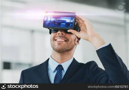 business, technology, augmented and virtual reality concept - businessman with some machine on display of vr headset at office. businessman with virtual reality headset at office