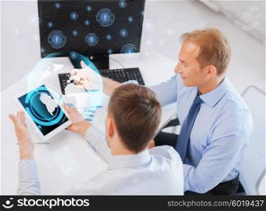 business, technology, communication and people concept - businessmen with virtual globe projection and contact icons on tablet pc and computer at office