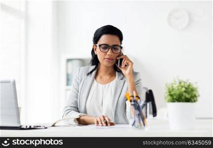 business, technology, communication and people concept - happy businesswoman with papers calling on smartphone at office. businesswoman calling on smartphone at office