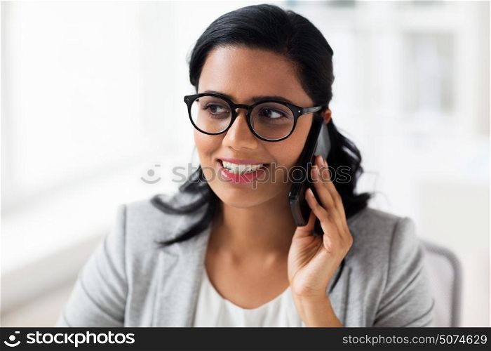 business, technology, communication and people concept - happy smiling businesswoman or secretary calling on smartphone at office. businesswoman calling on smartphone at office