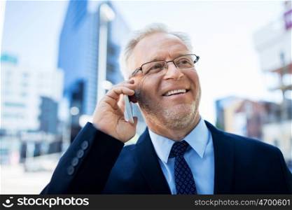 business, technology, communication and people concept - happy smiling senior businessman calling on smartphone in city
