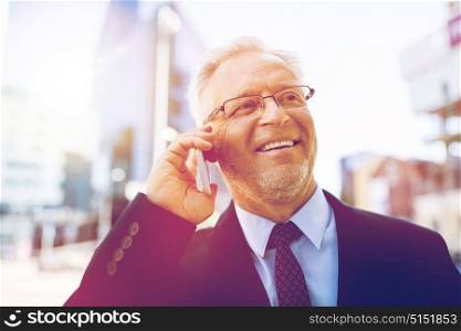 business, technology, communication and people concept - happy smiling senior businessman calling on smartphone in city. smiling old businessman calling on smartphone
