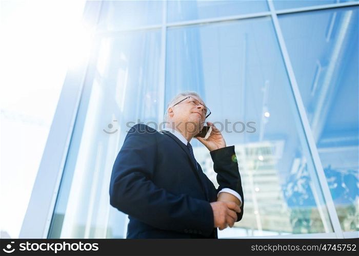 business, technology, communication and people concept - senior businessman with coffee cup calling on smartphone in city