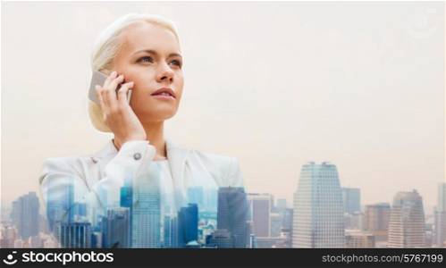 business, technology, communication and people concept - serious businesswoman with smartphone talking over city background