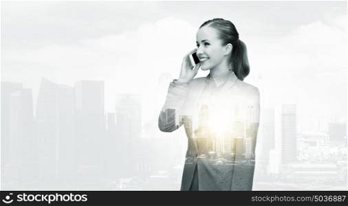 business, technology, communication and people concept - smiling businesswoman calling on smartphone over city buildings and double exposure effect. smiling businesswoman calling on smartphone