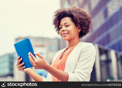 business, technology, communication and people concept - young smiling african american businesswoman with tablet pc computer in city