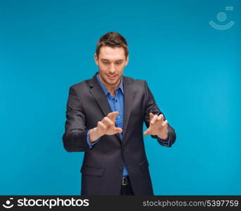 business, technology, communication concept - businessman working with imaginary virtual screen