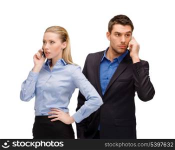 business, technology, communication concept - businesswoman and businessman with cell phones calling