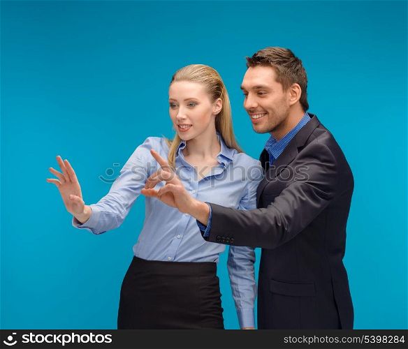 business, technology, communication concept - businesswoman and businessman working with imaginary virtual screen