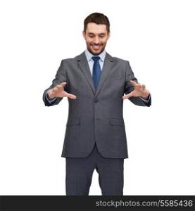 business, technology, communication concept - smiling businessman working with imaginary virtual screen