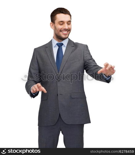 business, technology, communication concept - smiling businessman working with imaginary virtual screen