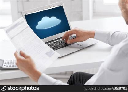 business, technology, computing and people concept - close up of businessman with cloud icon on laptop computer screen working at office