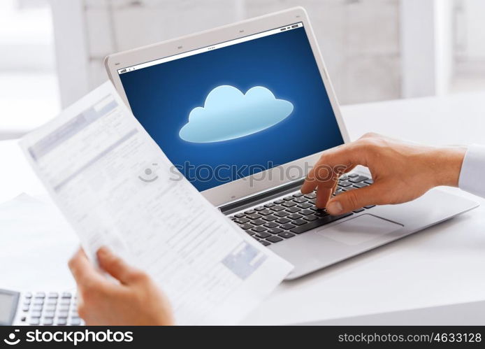 business, technology, computing and people concept - close up of businessman with cloud icon on laptop computer screen working at office