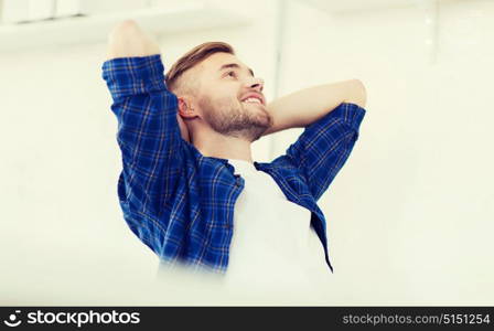 business, technology, education and people concept - happy young creative man or student with computer at office. happy creative man with computer at office