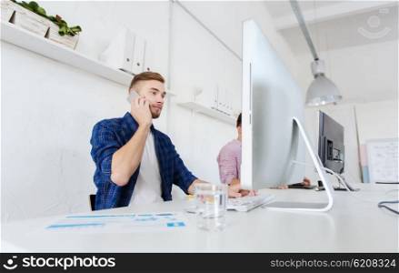 business, technology, education and people concept - happy young creative man or student with computer at office calling on smartphone