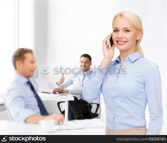 business, technology, education and people concept - smiling young businesswoman with smartphone making call in office