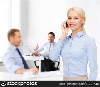 business, technology, education and people concept - smiling young businesswoman with smartphone making call in office