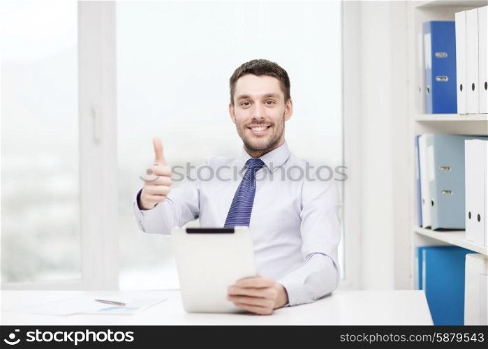 business, technology, finances and internet concept - smiling businessman with tablet pc computer and documents at office showing thumbs up