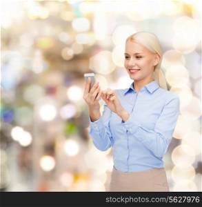 business, technology, holidays and people concept - smiling young businesswoman with smartphone