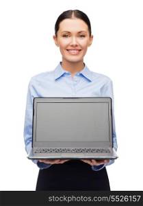 business, technology, internet and advetising concept - friendly young smiling businesswoman with laptop blank screen